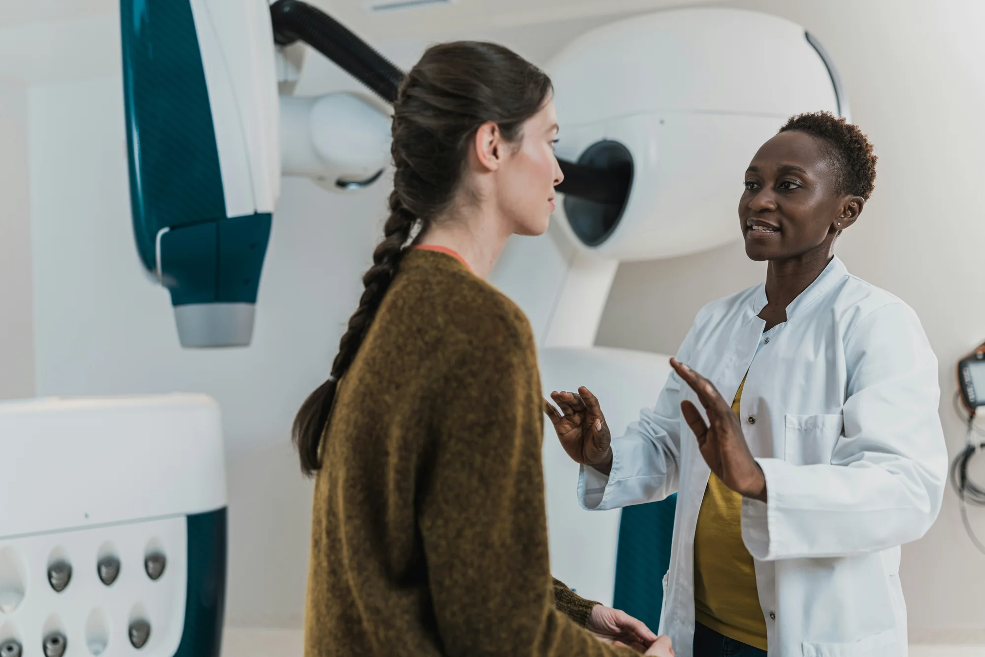 A radiographer explaining a scan to a patient