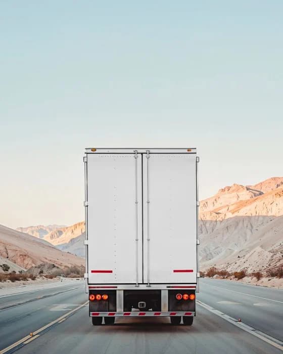 A trailer seen from behind on a mountain road