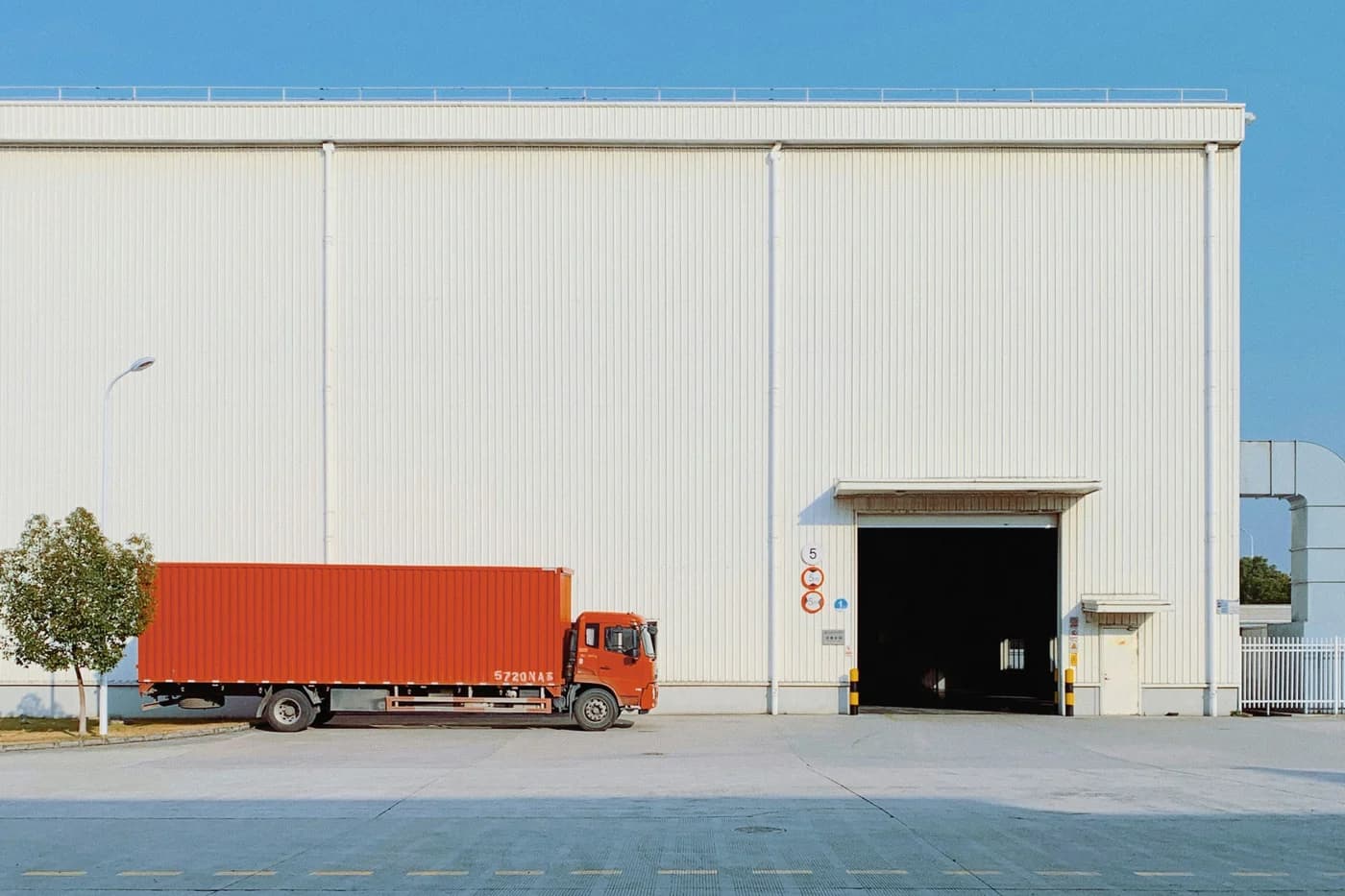 A truck at the dock of a logistics warehouse